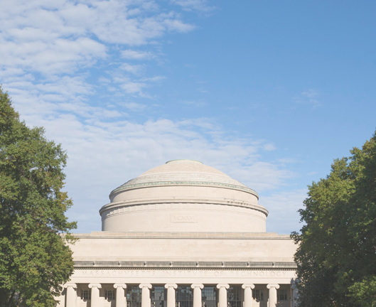 Building with domed roof, pillars, trees and blue sky